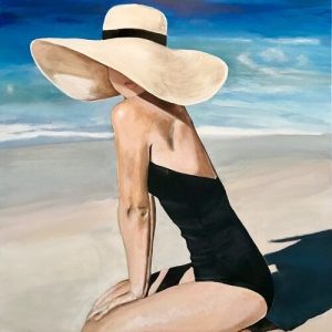 Kalapos nő a tengerparton